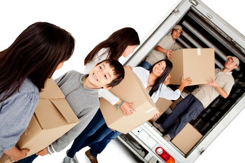 Furniture collection team handling a sofa in a London home