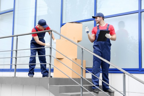 Moving company team in London handling packed boxes during relocation