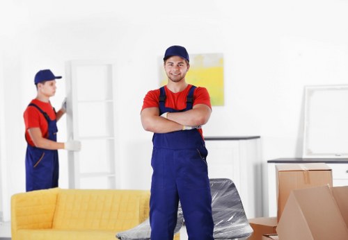 Removal team planning a London house move with boxes and furniture