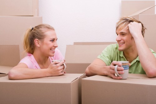 Moving team handling items in a London flat with stairs
