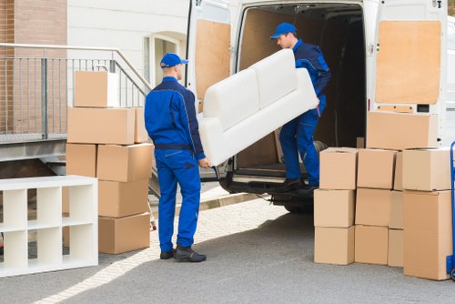 Loading furniture into a van on a London street