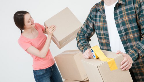 London home move service with boxes and furniture in a residential street