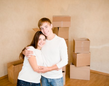Movers transporting household items through a city building
