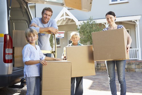 Helper carrying furniture into a London flat