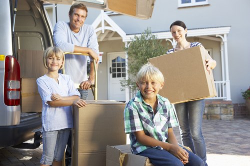 Relocation team organizing household items inside a moving vehicle
